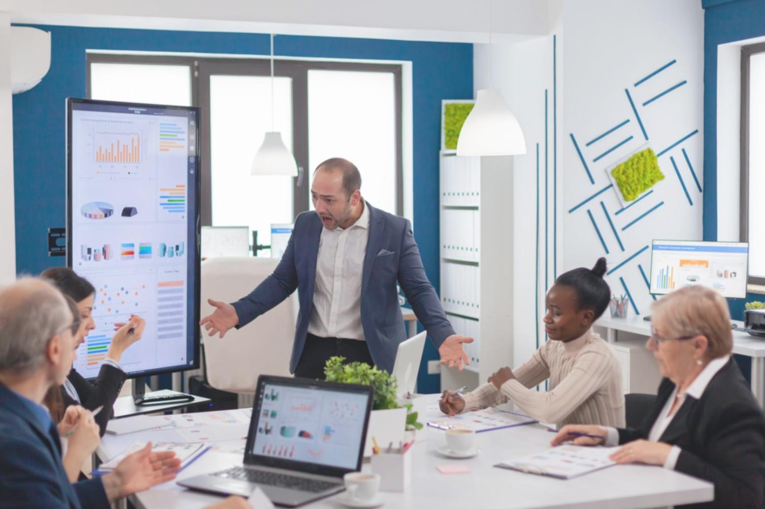 Business leadership training session with professionals analyzing financial data and strategic planning documents